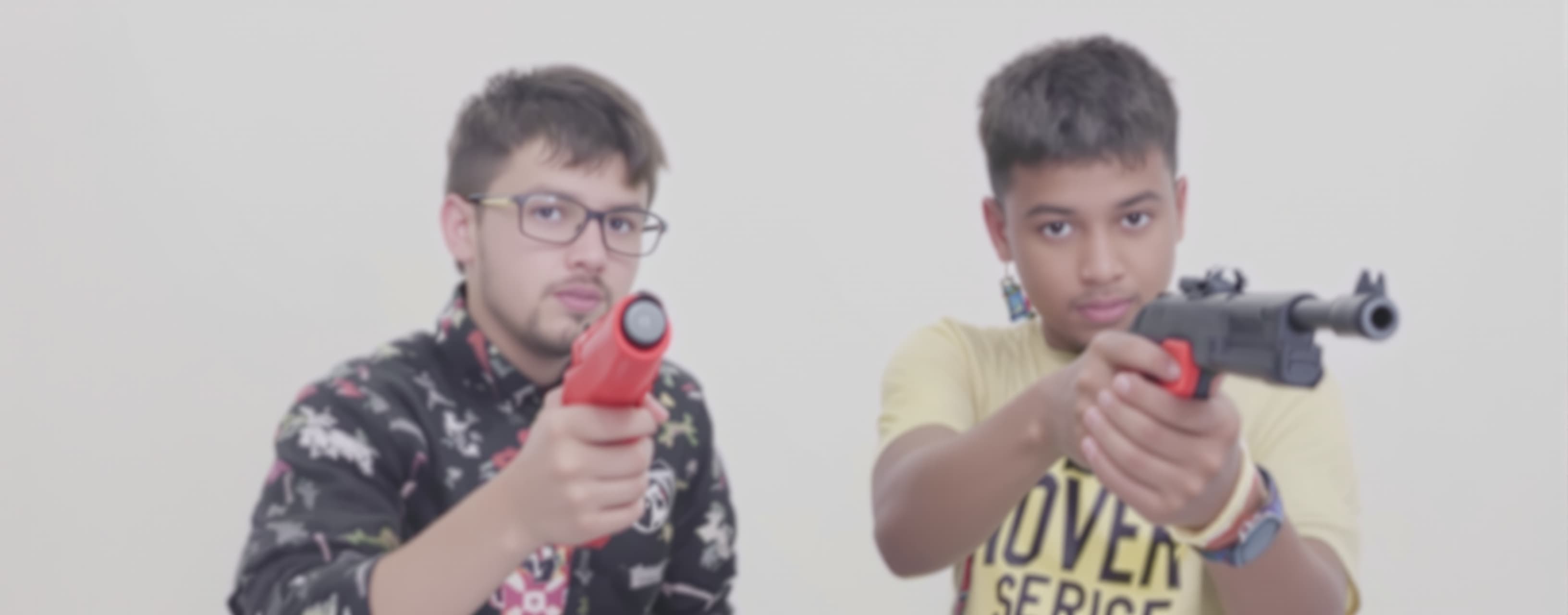 Given the sentence "Two young boys with toy guns and horns."...