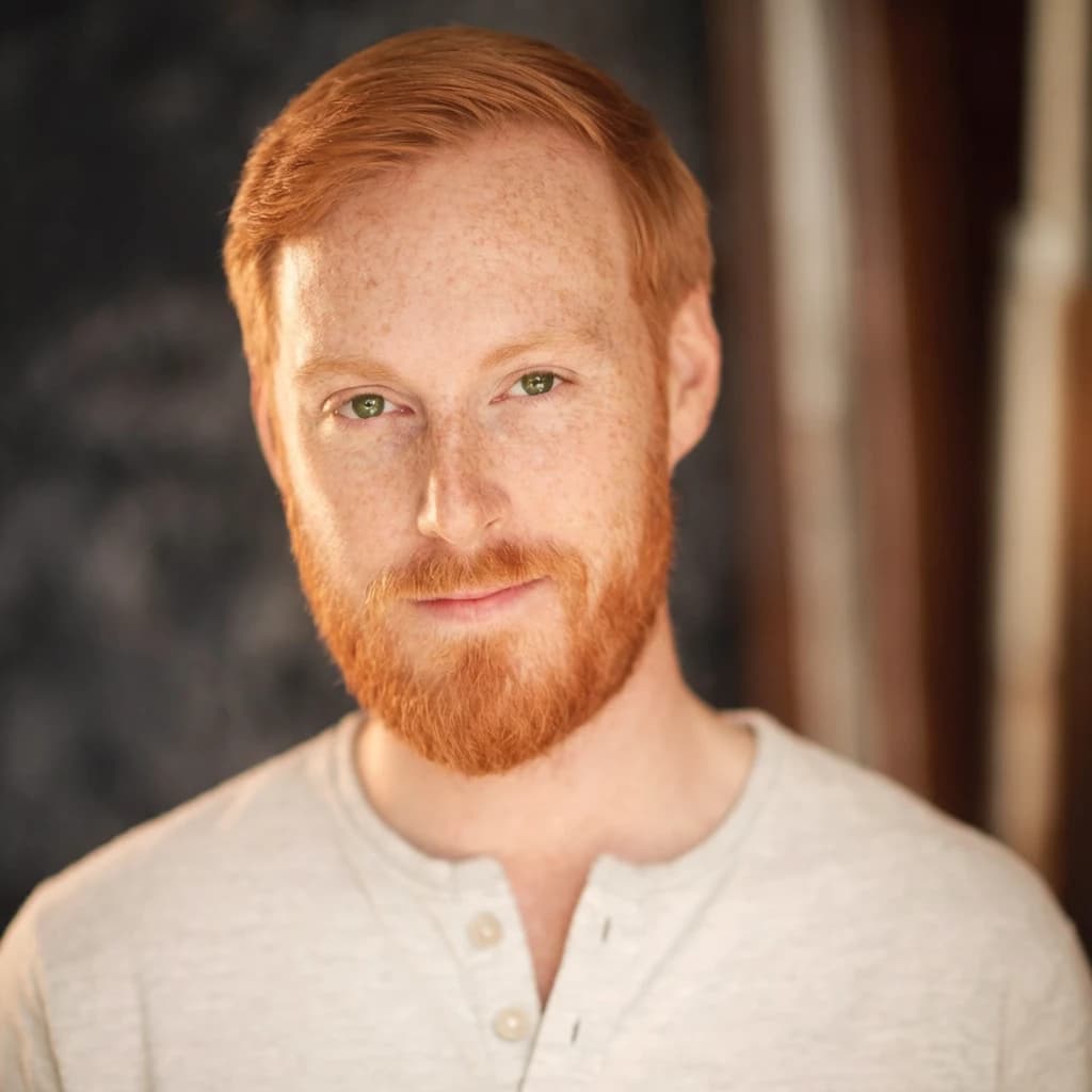 Shoot a natural light headshot of a red-haired man with freckles, green eyes.