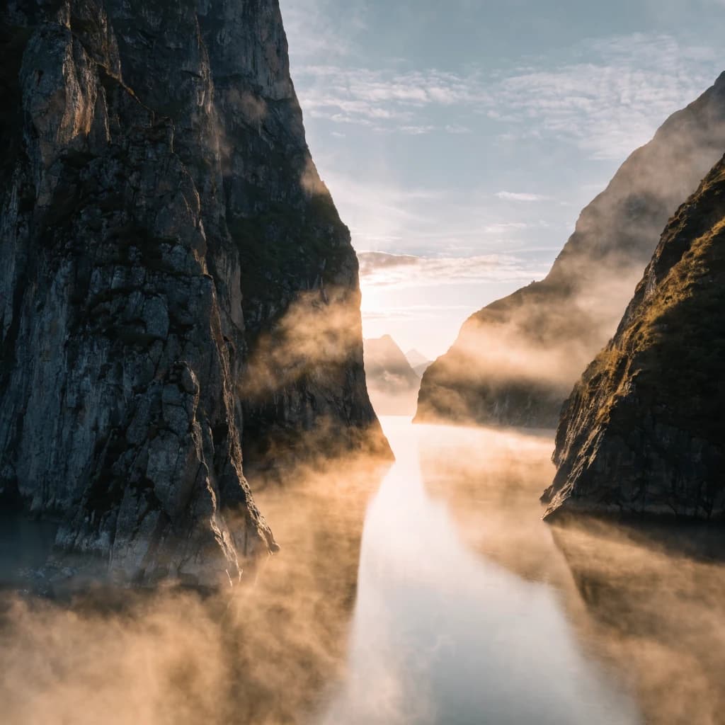 Frame a foggy fjord at sunrise, cliffs looming.