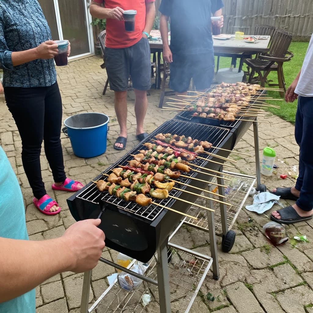 Friends grill skewers on a slightly messy patio.