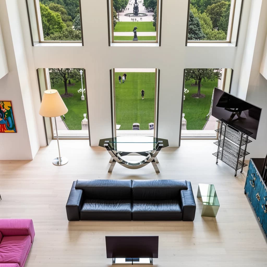 My apartment overlooks Central Park. It’s very luxurious, very expensive, and the furniture is minimal — a black leather couch, a glass coffee table with chrome legs, an Arne Jacobsen floor lamp. A big-screen television set rests on a steel shelving unit. A David Onica painting hangs above the couch. There’s a stainless steel and glass cocktail table. A powder-blue sofa. A thirty-inch digital TV.
