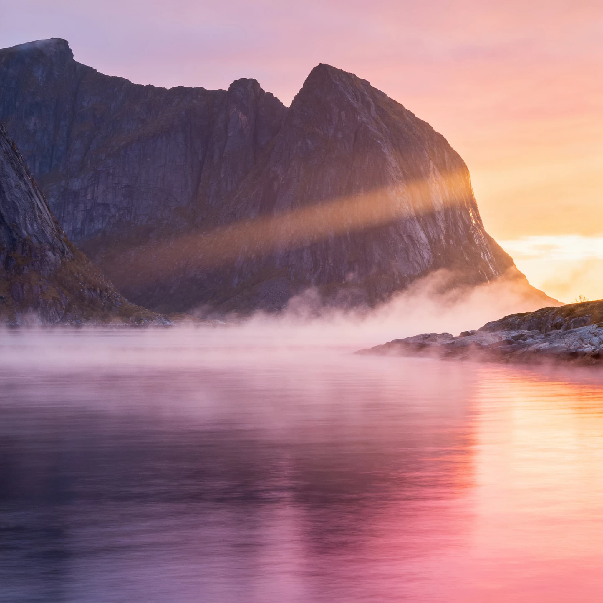Frame a foggy fjord at sunrise, cliffs looming.