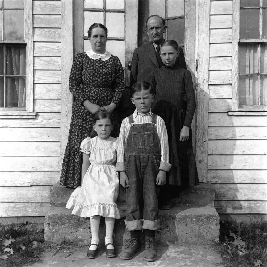 Everybody holds still and nobody smiles for the family portrait. It's 1928 in Kansas