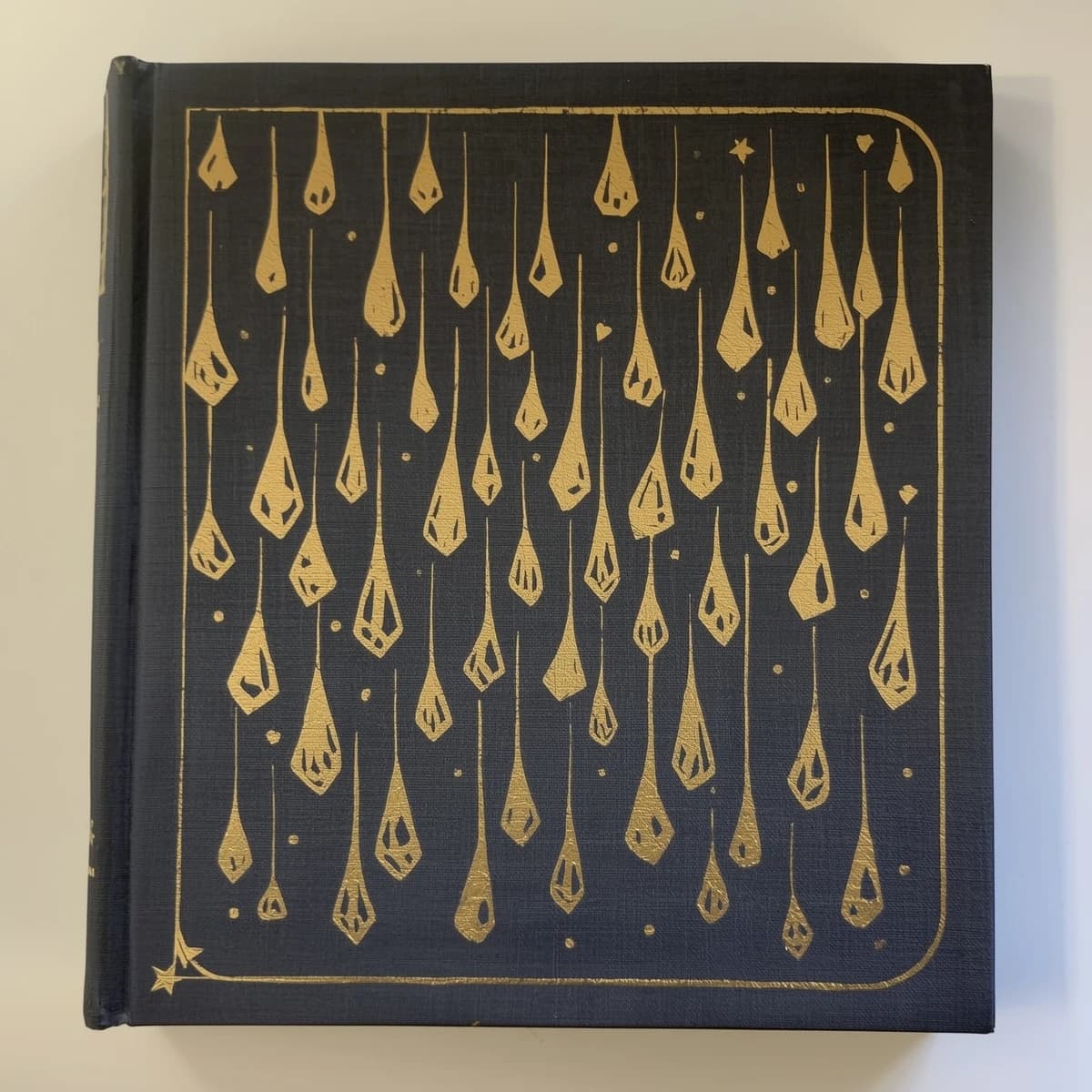 Illustrate a book cover with gold foil drop caps.